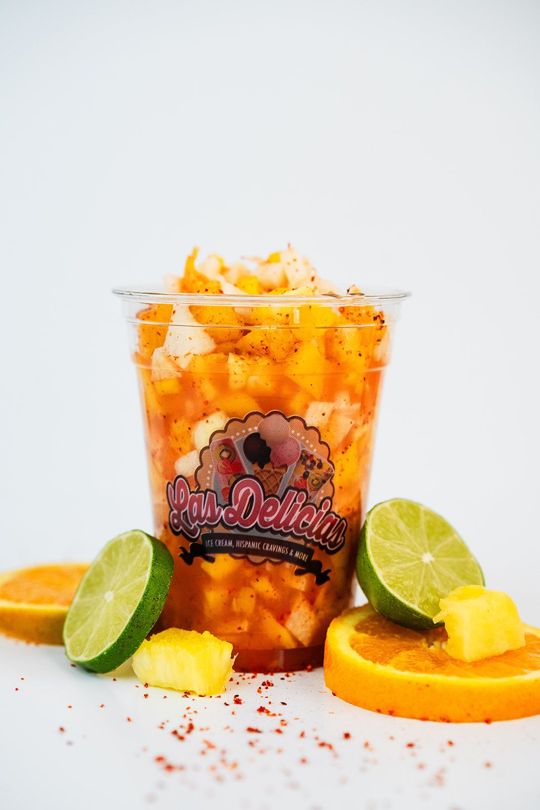 A Las Delicias mangonada with mango, chamoy, and toppings